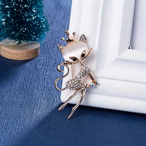 Broche chat chic avec opale et strass en finition dorée sur fond bleu élégant