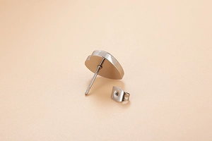 Macro shot of silver heart shell stud earrings with stainless steel butterfly backings