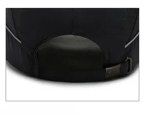 Detail of adjustable metal buckle and breathable mesh on black quick-dry baseball cap