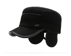 Detail of winter thermal flat cap for men with ear flaps and side metal plaque