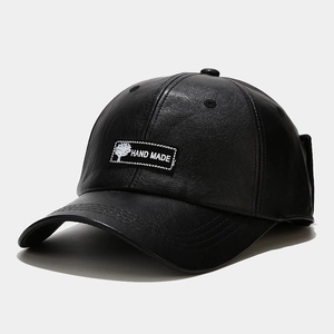 Close-up of black PU leather baseball cap with Hand Made embroidery and tree logo detail