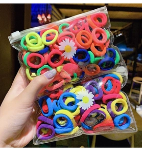 Detailed view of colorful high-elasticity hair ties in daisy printed zipper bags