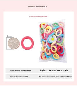 Close-up of 2.5cm macaron elastic hair ties with coin size comparison and daisy bag
