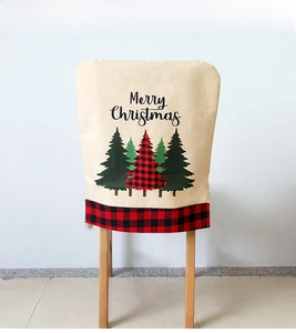 Detail of burlap Christmas chair cover with Merry Christmas text and plaid tree patterns