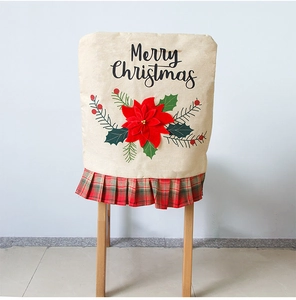 Detail of linen Christmas chair cover with red poinsettia and Merry Christmas print