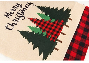 Close-up of burlap Christmas chair cover with buffalo plaid tree and Merry Christmas text