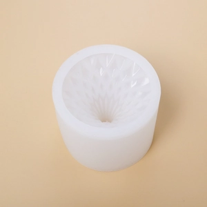 Detailed top view of a translucent cylindrical silicone mold with geometric diamond patterns