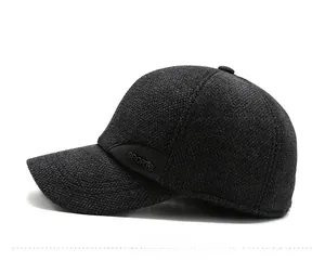 Detail view of winter baseball cap with ear flaps and embossed sports logo patch