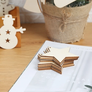 Rustic wooden star and snowman ornaments for Christmas tree decor on a wooden table