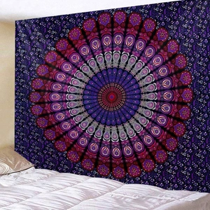 Bedroom setting with a purple mandala tapestry hanging as a bohemian wall decoration