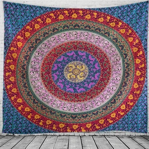 Detailed pattern of Mandala wall tapestry with paisley motifs on white brick wall