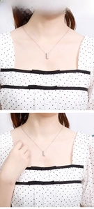 Detailed close-up of a silver rectangular column pendant necklace for minimalist fashion