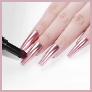 Nail art cushion chrome powder pen applying metallic red glitter on rose gold coffin nails