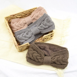 Detail of cable knit headbands with soft fleece lining in pink, grey and brown colors