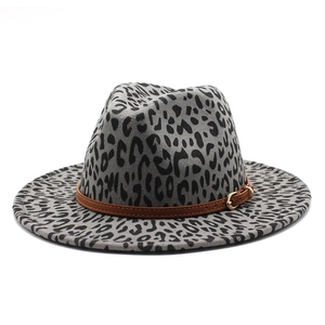 Detail of leopard print fedora hat with brown leather belt and gold buckle