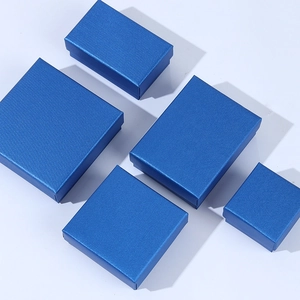 Top view of peacock blue jewelry gift boxes in various sizes on a clean white background