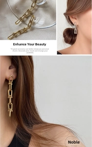 Detail of U-shaped chain link earrings in gold and silver finish on a model