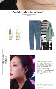 Detail view of gold U-link chain drop earrings and model styling with casual outfit