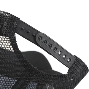 Detail view of the adjustable black snapback strap and mesh panel on the trucker hat