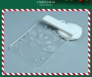 Unlit detail of transparent acrylic Christmas snowman ornament with laser engraving