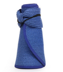 Foldable navy blue straw beach hat with wide brim showing portable rolled-up storage