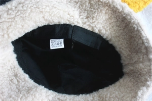 Detailed close-up showing inner lining seams and wash label of plush fleece bucket hat