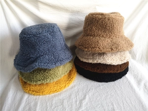 Collection of colorful plush bucket hats showing thick faux fur texture in seven colors