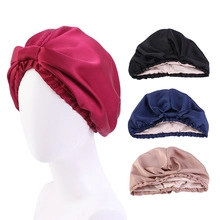 Detail view of elastic silk turbans in multiple colors with twisted knot design