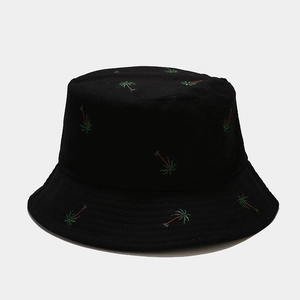 Close-up of coconut tree embroidery on a black cotton bucket hat showing detailed texture