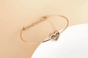 Close-up of rose gold mama heart bracelet with adjustable chain for Mother's Day gift