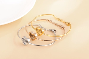 Detailed view of mama heart bracelets in gold, silver, and rose gold finishes