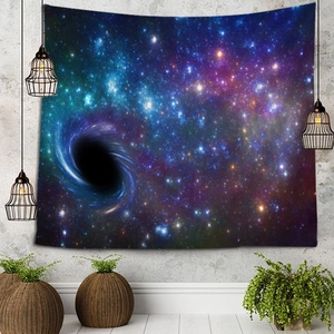 Detail of star galaxy tapestry hanging on a grey wall with modern decor and green plants