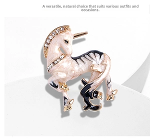 Detail view of unicorn brooch featuring cream marble enamel and sparkling rhinestones