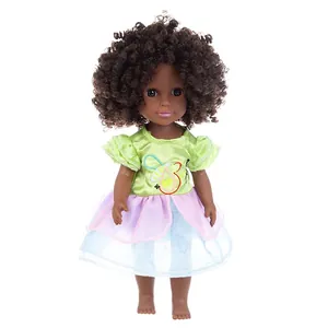 Deep skin tone girl doll with curly hair wearing a green bee embroidery dress