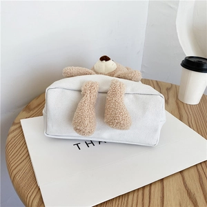 Détail du sac cabas en toile blanche avec ours en peluche 3D sur table épurée