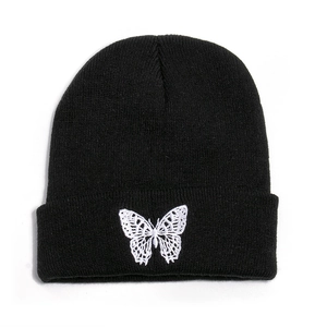 Black knit beanie with white lace butterfly embroidery, stylish autumn winter headwear