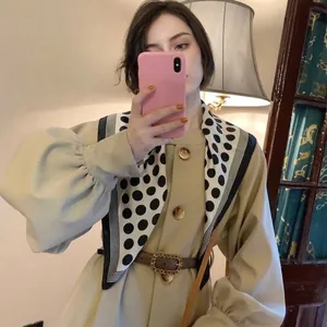 Elegant 70x70 women scarf with polka dot pattern and beige fabric detail on coat