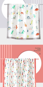 Detail of soft cotton gauze baby blankets with dinosaur and mushroom printed patterns