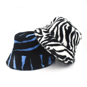 Winter plush faux fur bucket hats with zebra stripes in blue, black and white patterns