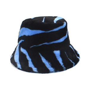 Winter plush bucket hat with stylish blue and black cow print pattern for women