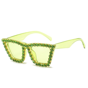Oversized cat-eye sunglasses in neon green with sparkling rhinestones and tinted lenses
