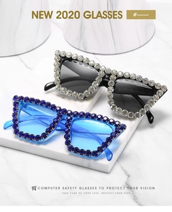 Close-up of luxury oversized sunglasses with crystals in black and translucent blue