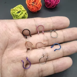 Eight-piece set of colorful U-shaped stainless steel nose rings held in palm
