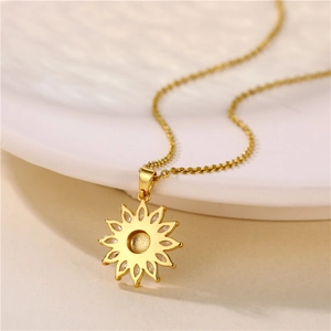 18K gold plated sunflower pendant necklace with zircon on white plate backdrop