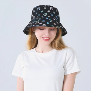 Detail of colorful M-letter and star patterns on a black rainbow bucket hat for women