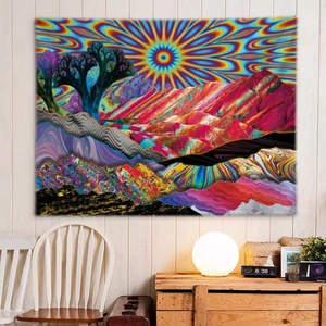 Abstract psychedelic tapestry with sun and mountains displayed over a wooden cabinet