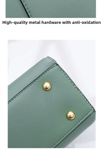 Detail showing high-quality anti-oxidation gold metal feet on green leather handbag