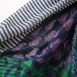 Detail of floral paisley pattern and navy striped texture on a cotton linen scarf