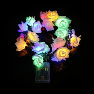 Detail view of multicolored LED rose string lights with foam petals and battery box
