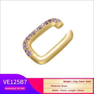Macro view of gold-plated brass ear cuff featuring two rows of purple zircon stones